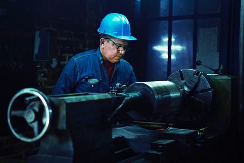 Metal worker on a machine - Photo by Rafael Juarez on Unsplash