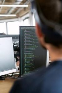 Man in front of computer screen - Image by ThisIsEngineering on Pexels