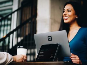 Smiling woman with laptop - Photo by Patrick Tomasso on Unsplash